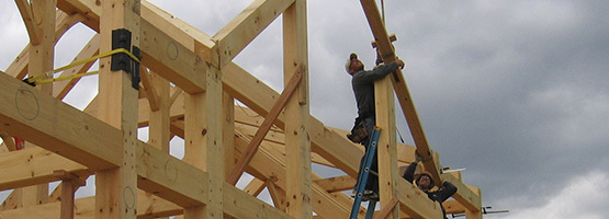 men assembling a timber frame structure