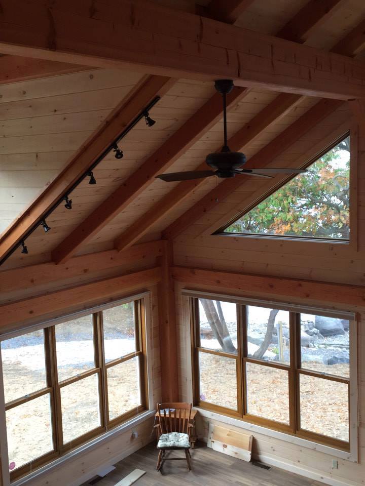 timber frame ceiling with a pickling board finish and a ceiling fan
