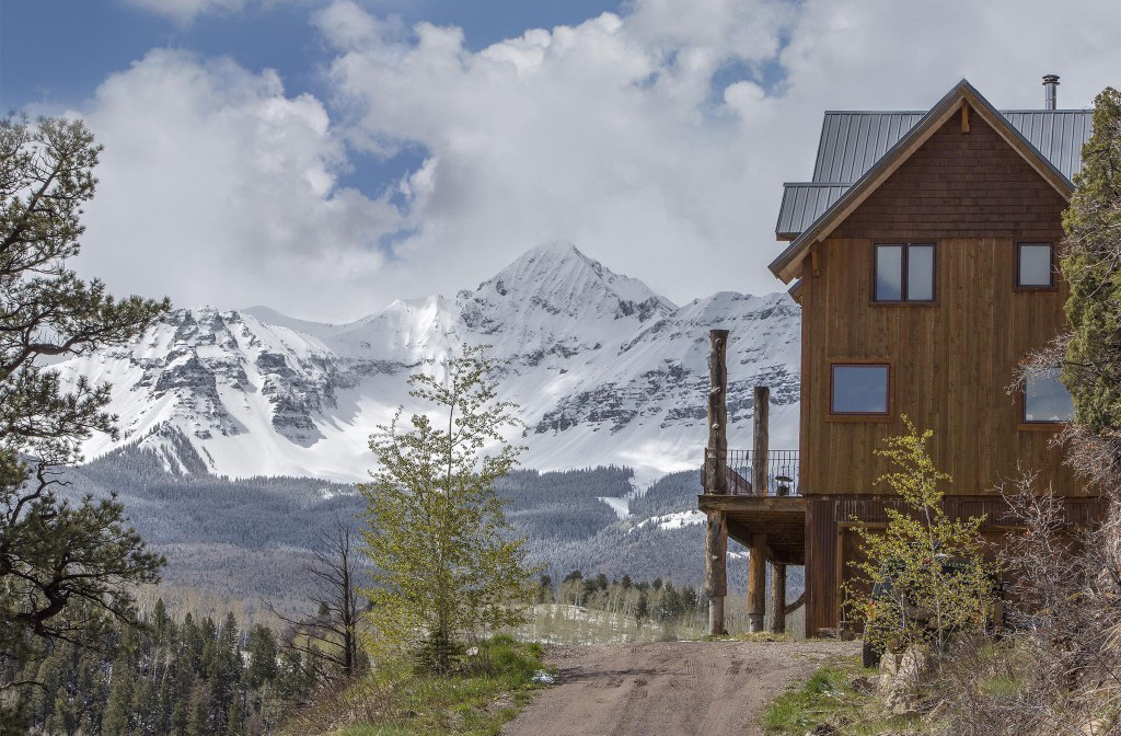 Mountains and an exterior of a timber frame cape