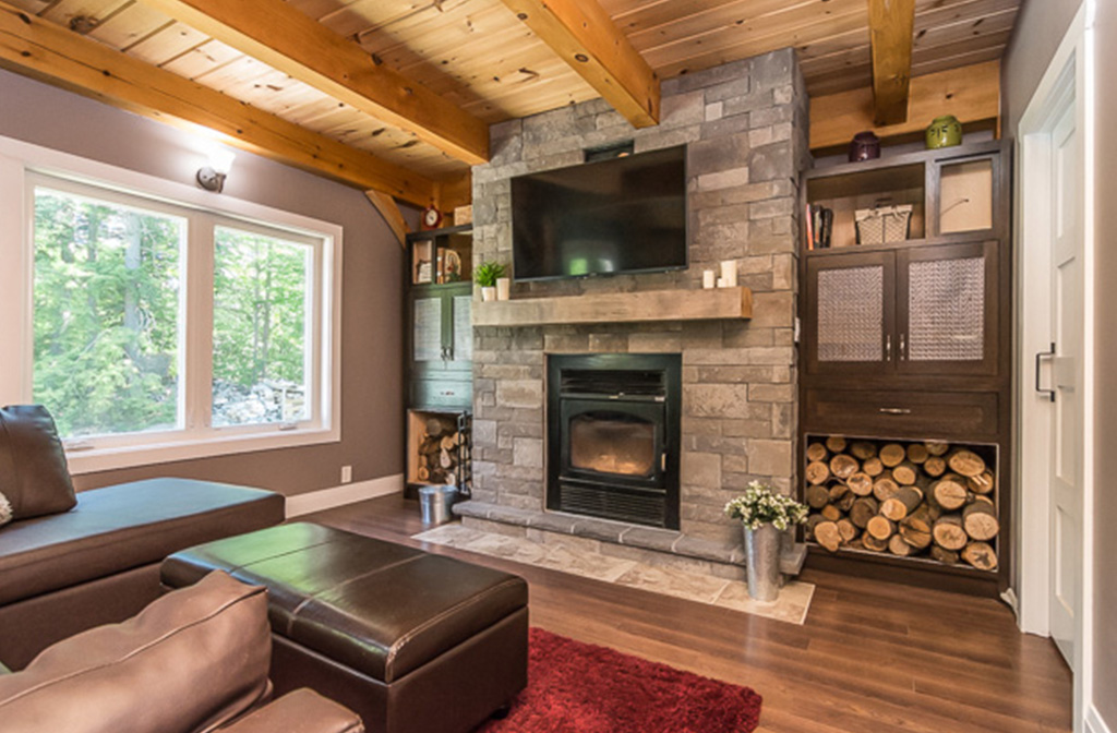 Stone fireplace in the living room of a timber frame dutch saltbox