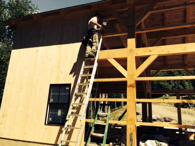 employee working on a timber frame barn