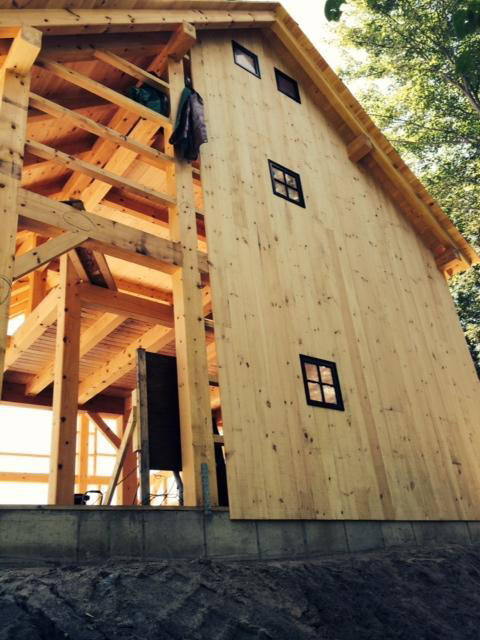 Half finished side of a timber frame barn