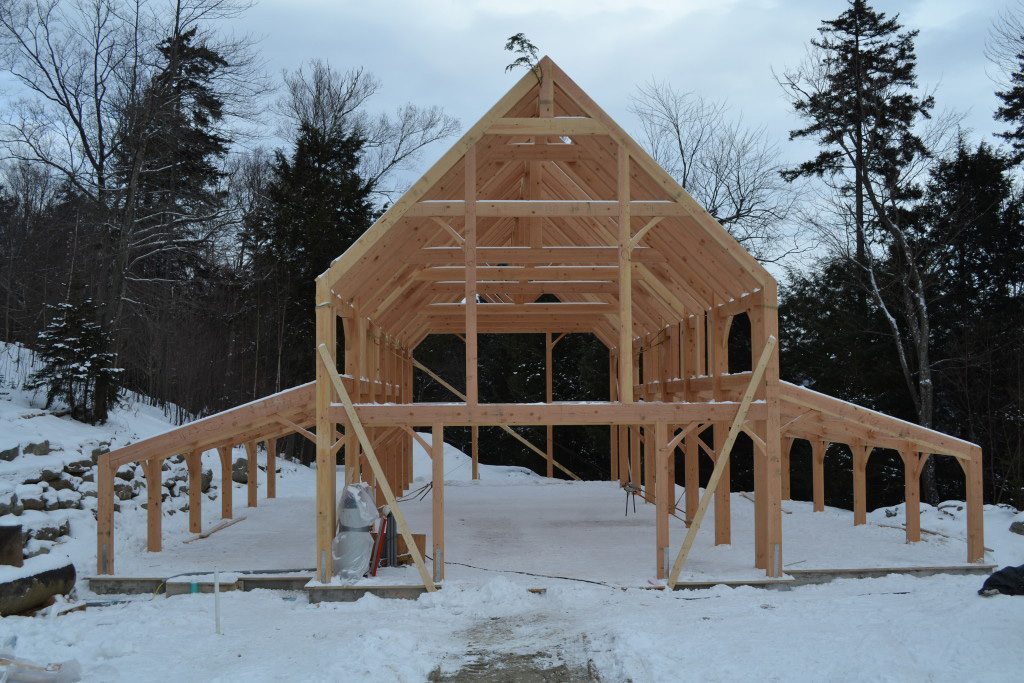 Timber frame structure of a barn in the winter