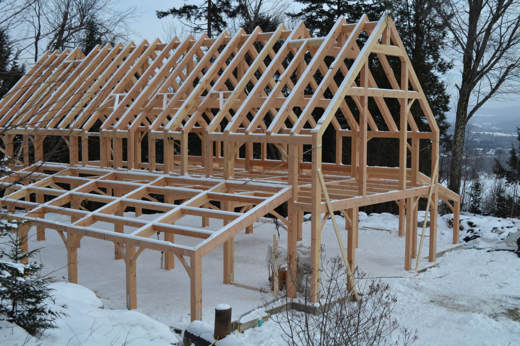 Timber frame structure of a barn in the winter