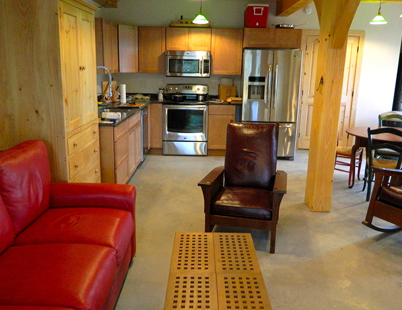 Kitchen and living room in a timber frame camp