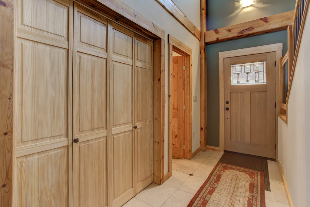 Entryway and closet in a timber frame cape