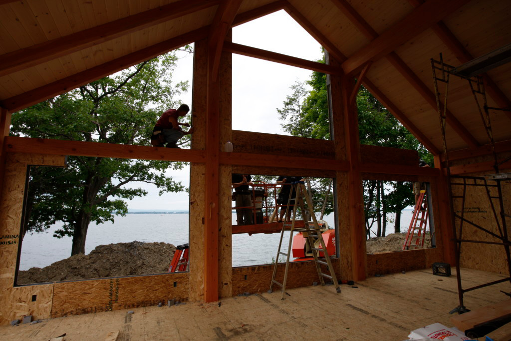 Timber frame cape structure from the inside with employees working