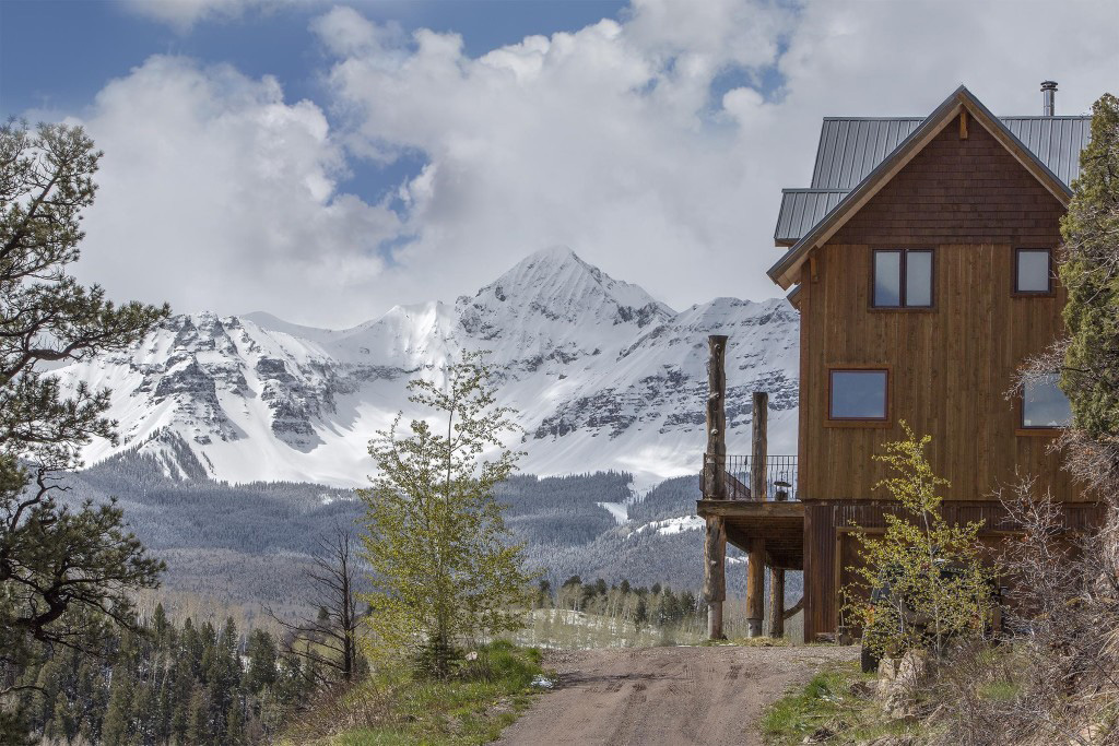Mountains and an exterior of a timber frame cape