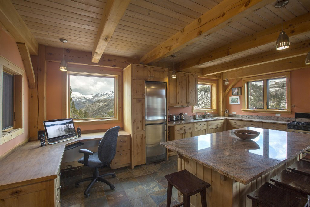 Kitchen and desk in a timber frame cape