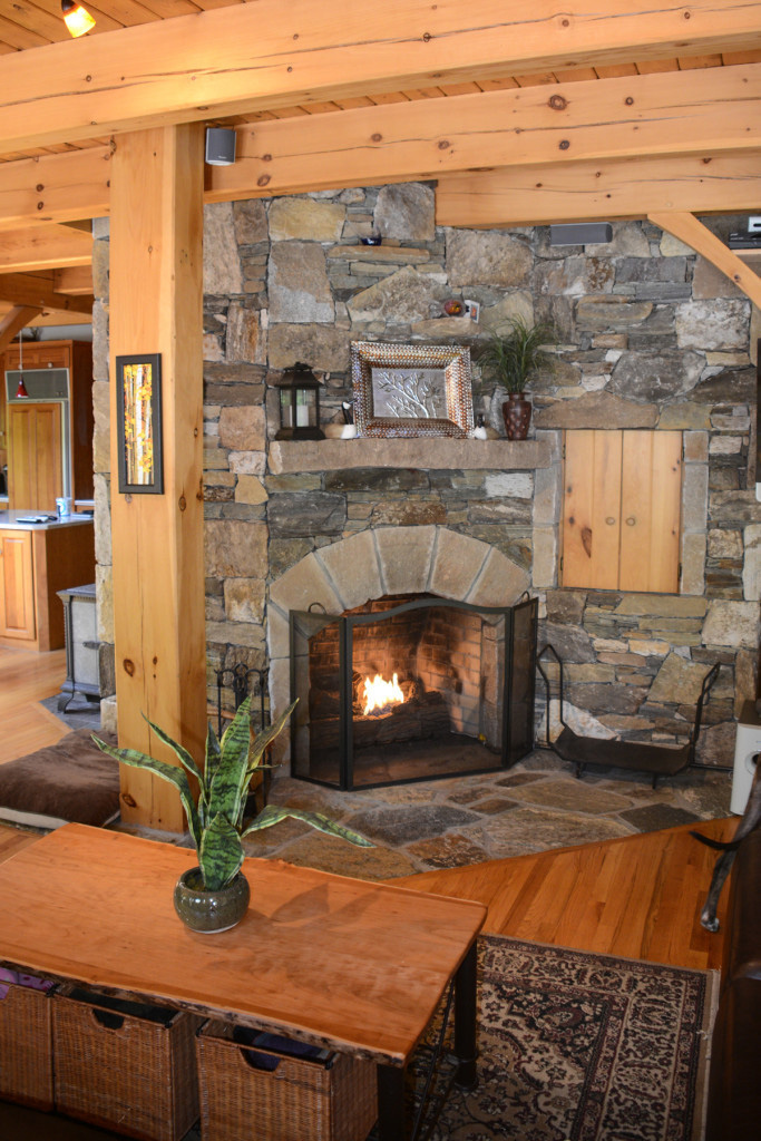 Stone fireplace in a timber frame colonial