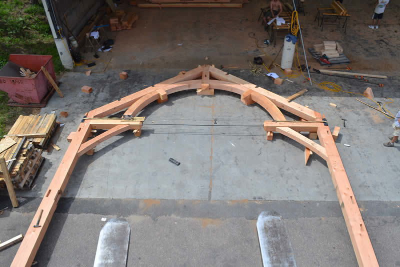 An arch of a timber frame colonial about to be raised to the structure