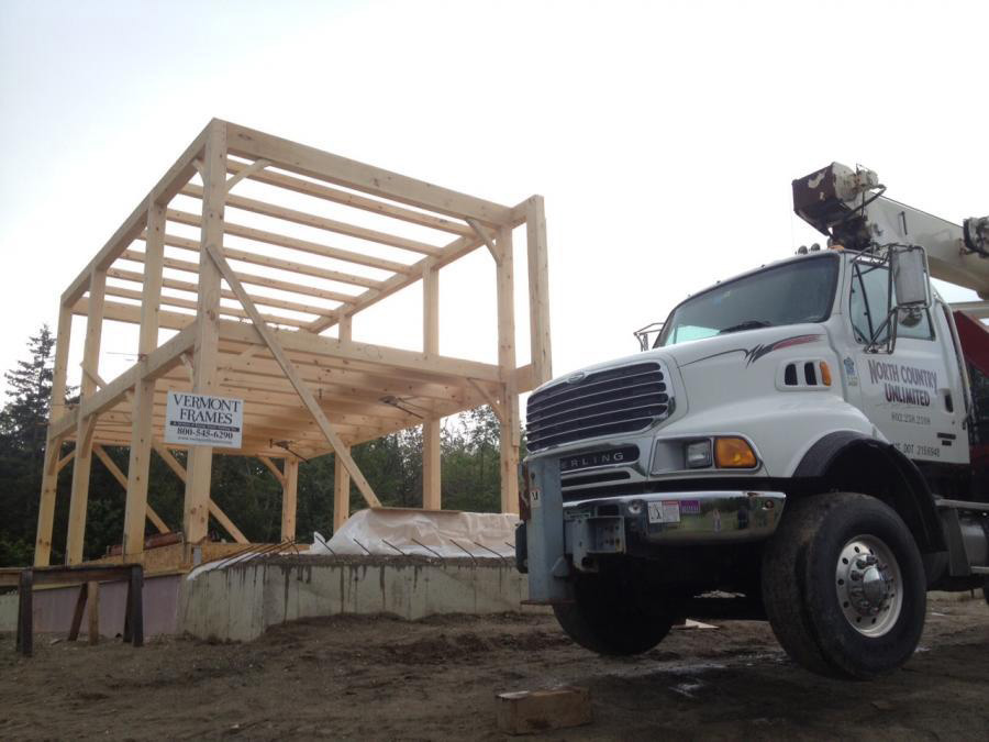 Vermont Frames timber frame structure and a truck