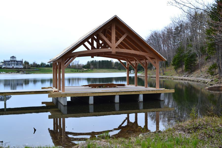 Finished timber frame pavilion on a lake