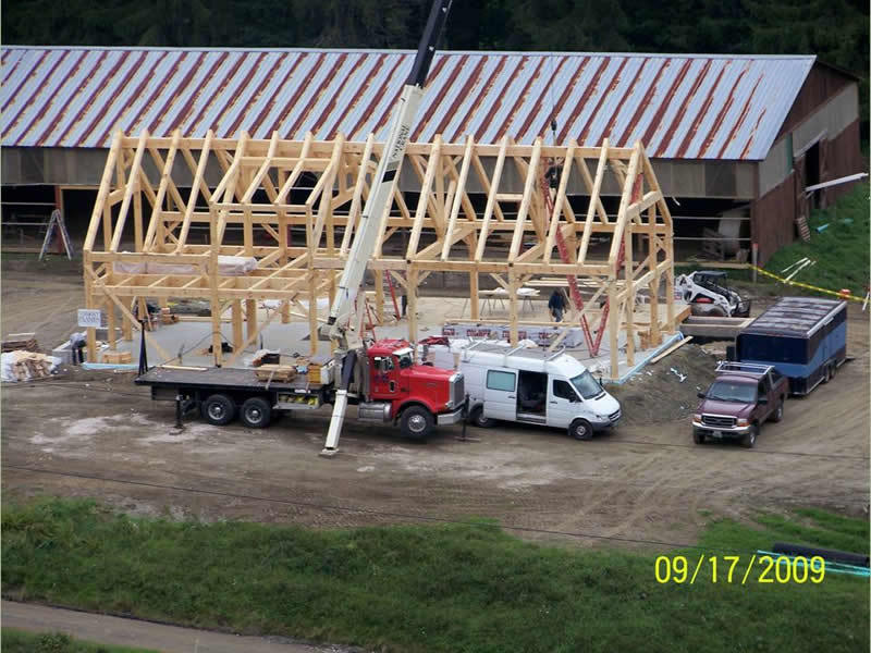 Crane assembling the timber frame structure of a restaurant