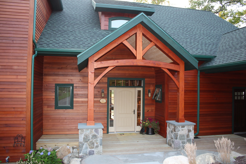 Timber Frame entryway on a wood-sided house