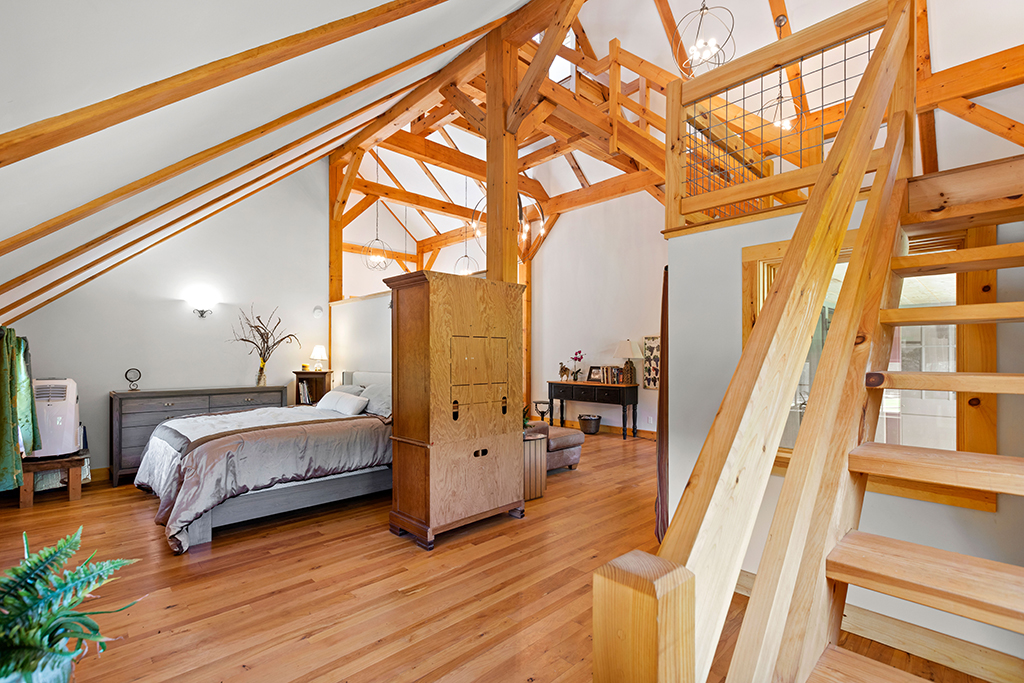 Finished interior of a timber frame home with a staircase